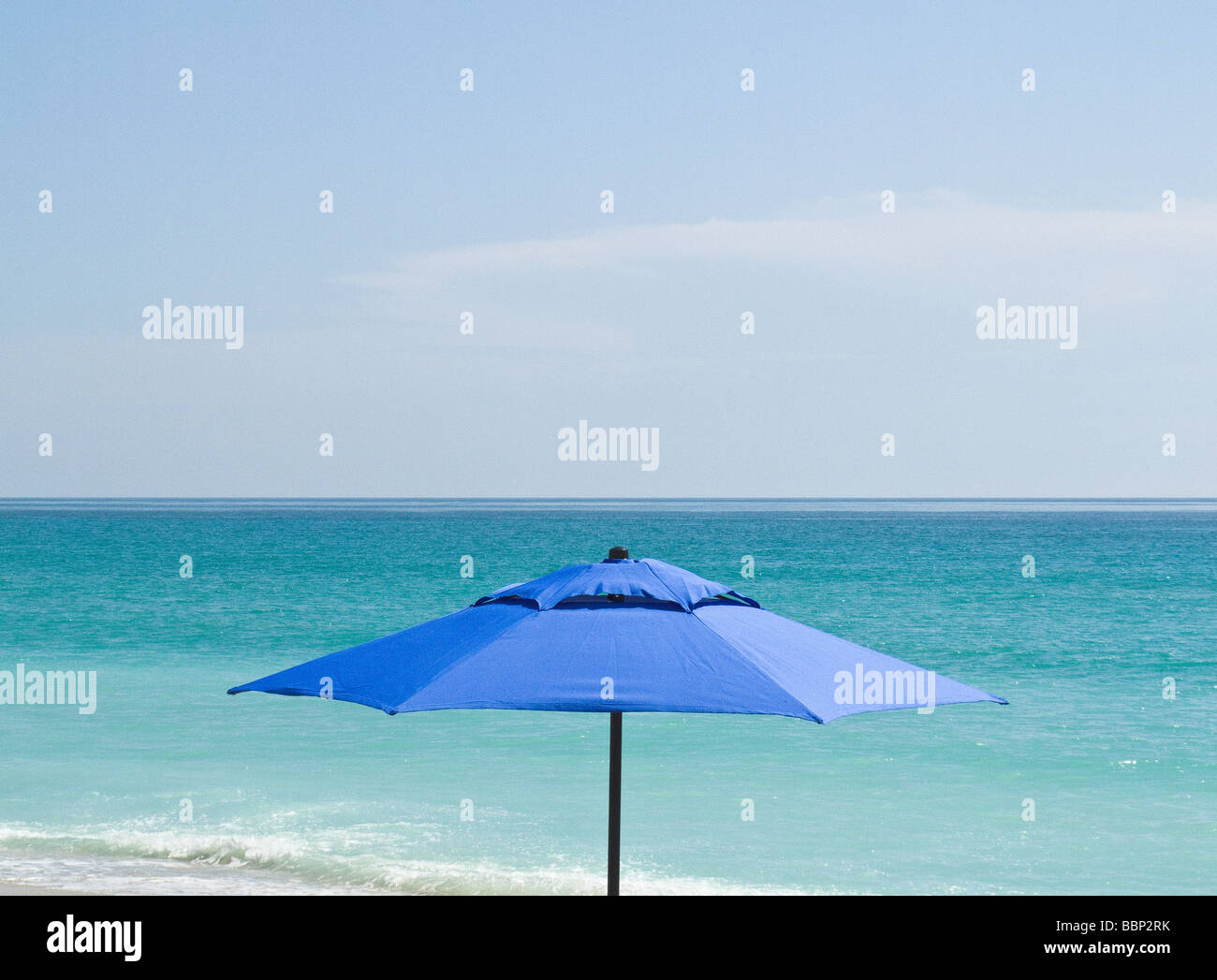 beach umbrella with water in background Stock Photo