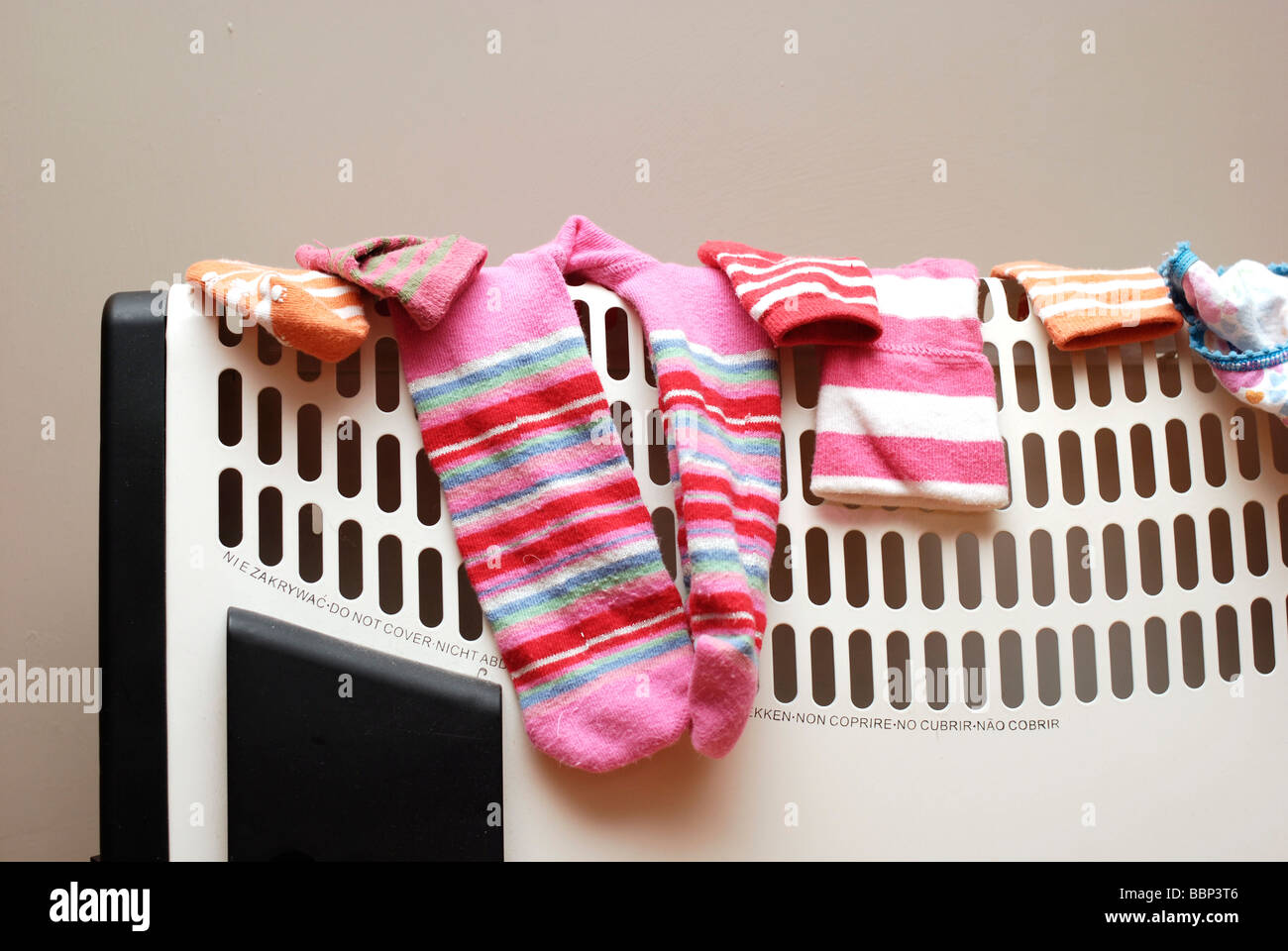 Childrens clothes drying on top of a convection heater Potentially  dangerous Stock Photo - Alamy