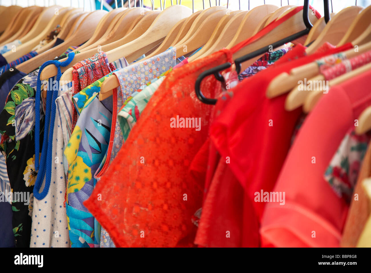 clothes on hangers in vintage secondhand shop Stock Photo