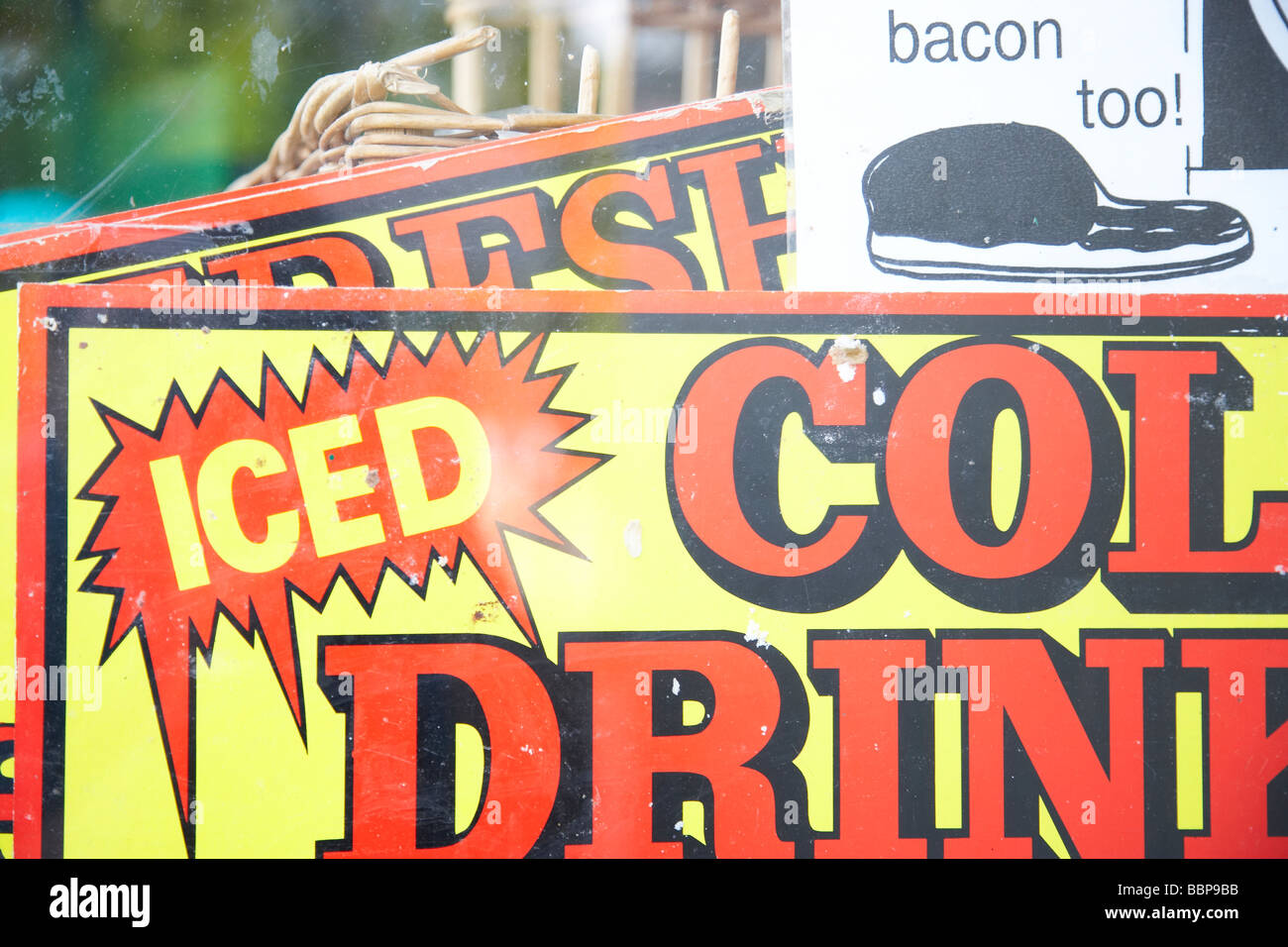 Iced cold drinks sign with bacon too sign Stock Photo Alamy