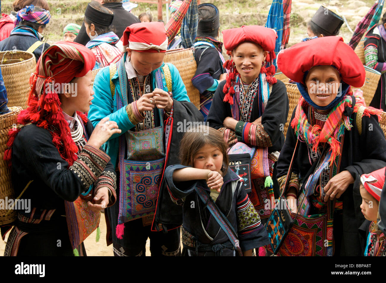 A  group of women and children wearing traditional costume from the Red Dao tribe in Sapa Northern Vietnam Stock Photo