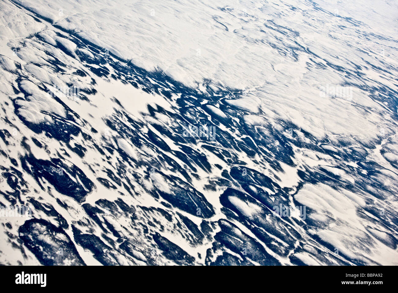 The awe-inspiring polar ice cap can be seen in this view from a plane, traveling from Frankfurt, Germany, to Washington, DC. Stock Photo