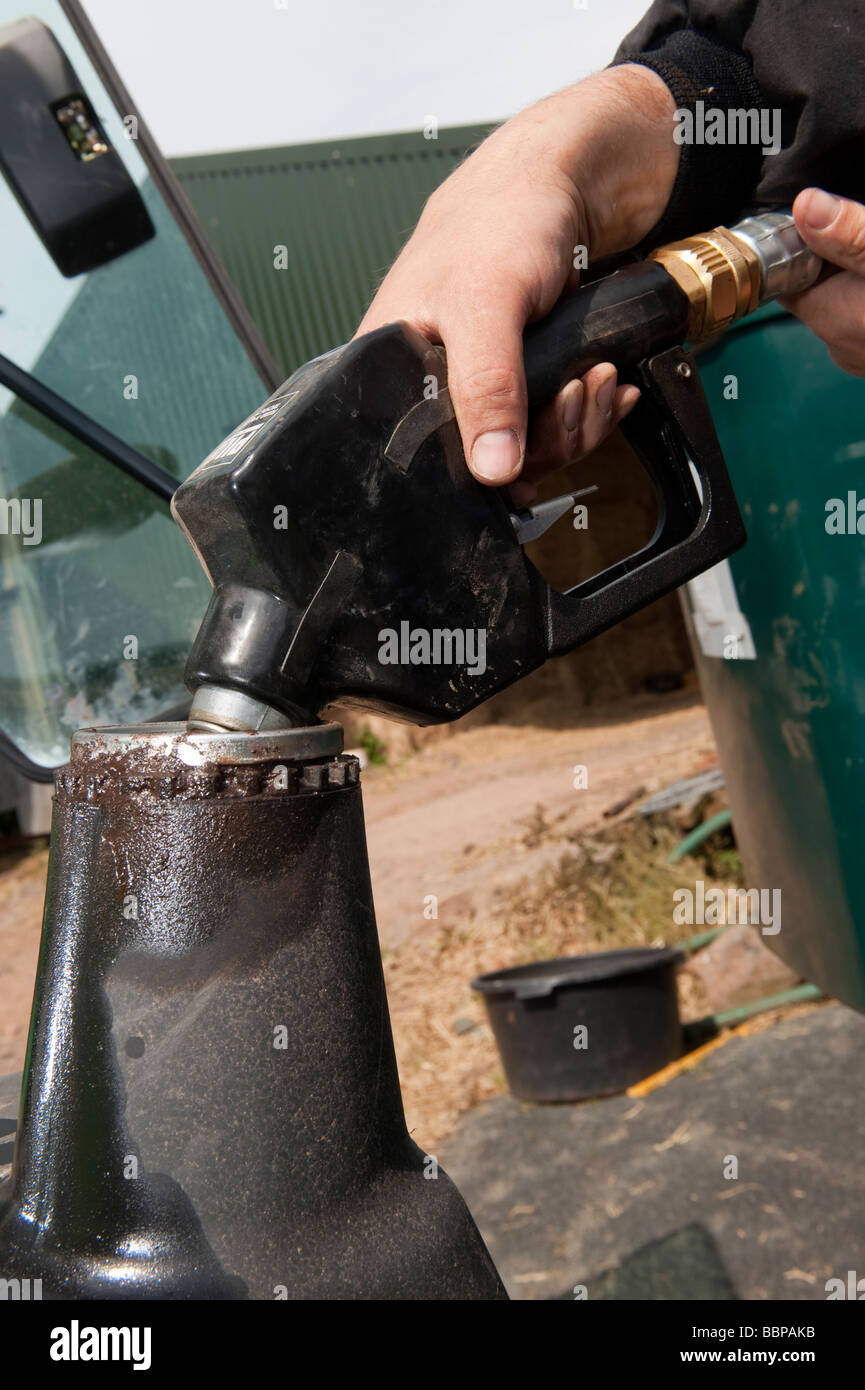 Farmer fueling tractor with red diesel Stock Photo