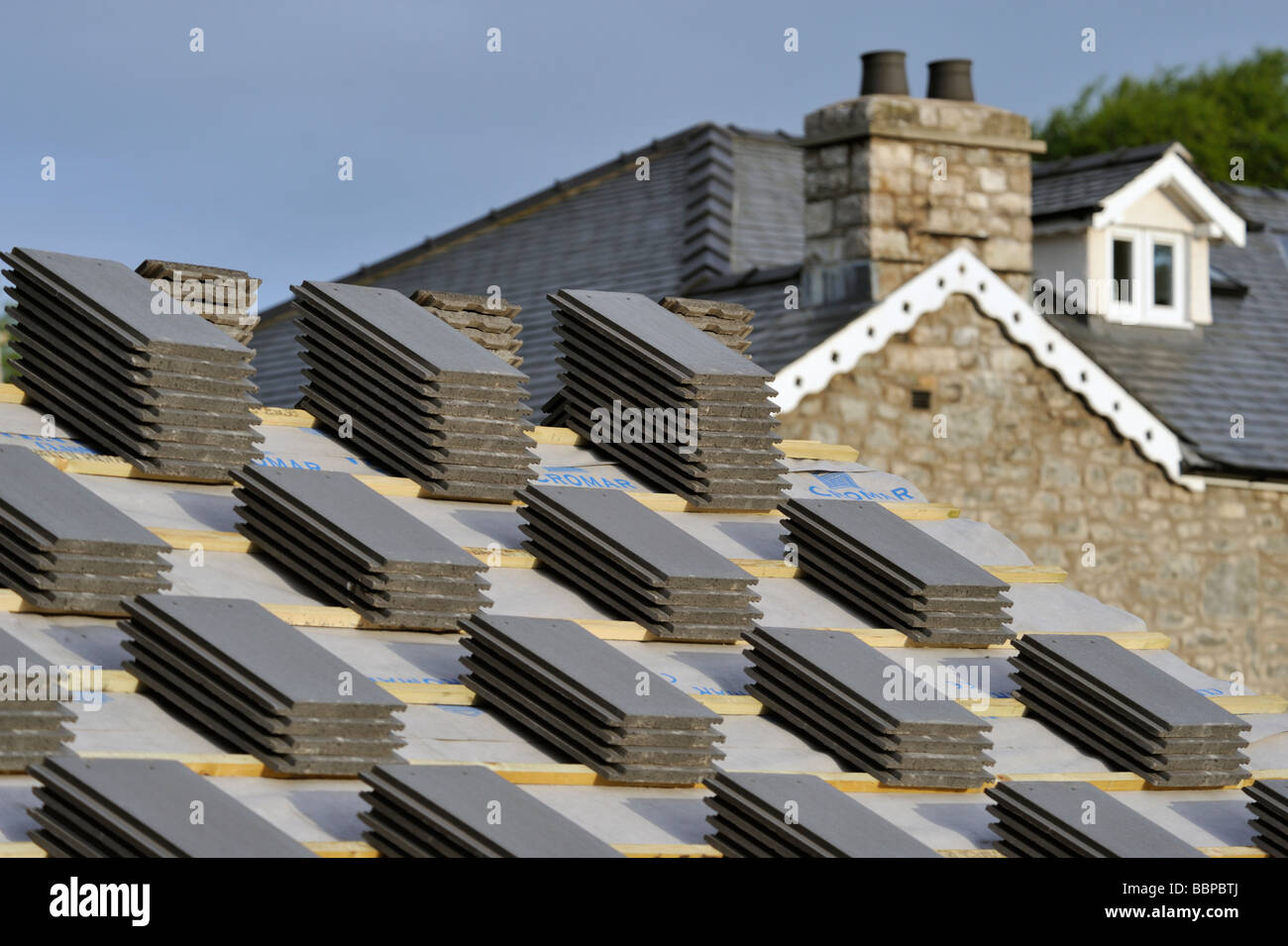 Roofing slates, stacked on roof, prior to re-roofing house. Stock Photo