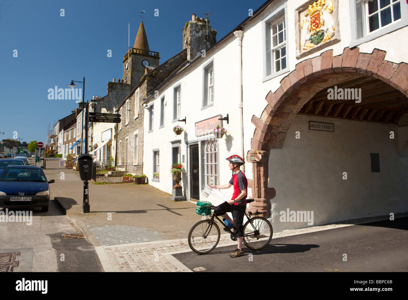 The town centre Whithorn cyclist reading a map at the Pend leading up to Whithorn Priory Galloway Scotland UK Stock Photo