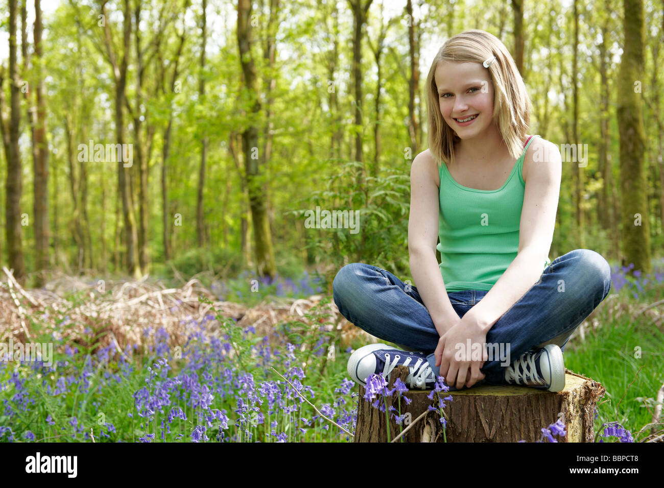 person. girl sitting in a forest enjoying the fresh air. young girl sitting...