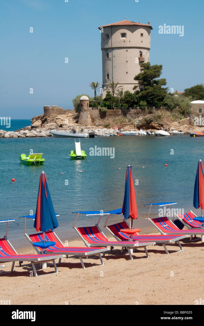 Umbrellas and sunbeds at Giglio Campese the main beach on the Island of Giglio or Isola del Giglio off the Tuscan coast Stock Photo