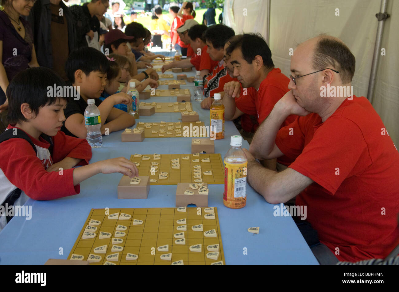 Children and adults play the Japanese game of chess called Shogi Stock Photo
