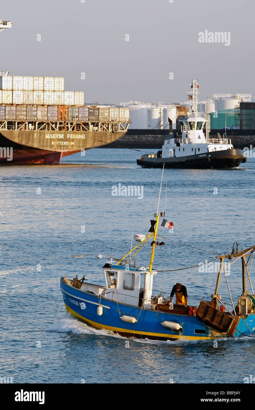 TRAWLER ENTERING THE PORT IN FRONT OF THE OIL TANKER TERMINAL, COMMERCIAL PORT, LE HAVRE, SEINE-MARITIME (76), NORMANDY, FRANCE Stock Photo
