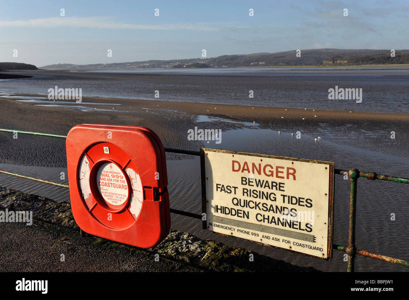 Warning signs for tides and quicksands at Arnside and the River Kent Estuary flowing into Morecambe Bay in Cumbria Stock Photo