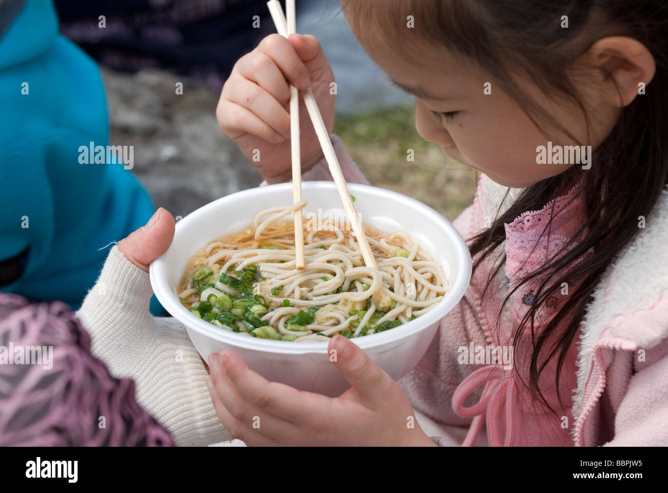 Japanese girl eating buckwheat soba noodle soup with chopsticks Stock Photo