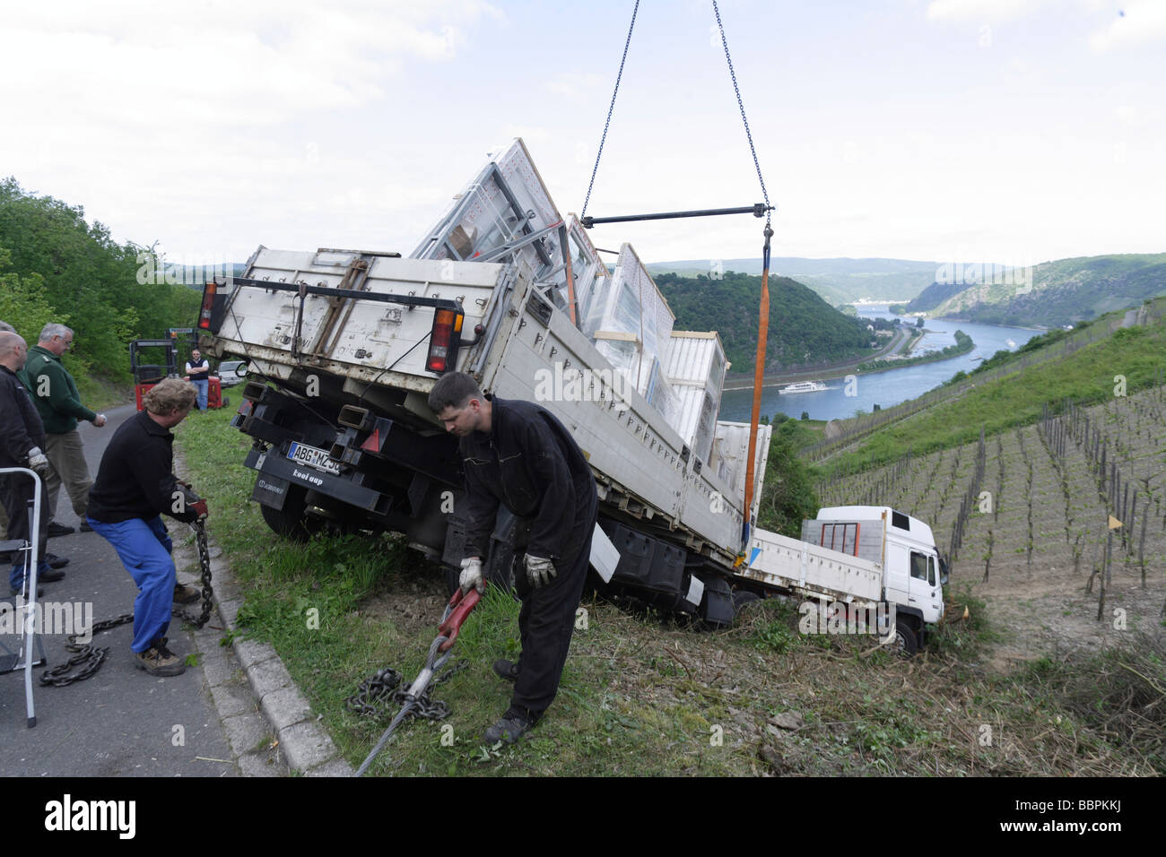 A salvage team drags a truck loaded with construction components from a vineyard overlooking the Rhine near Nochern, Rhein-Lahn Stock Photo