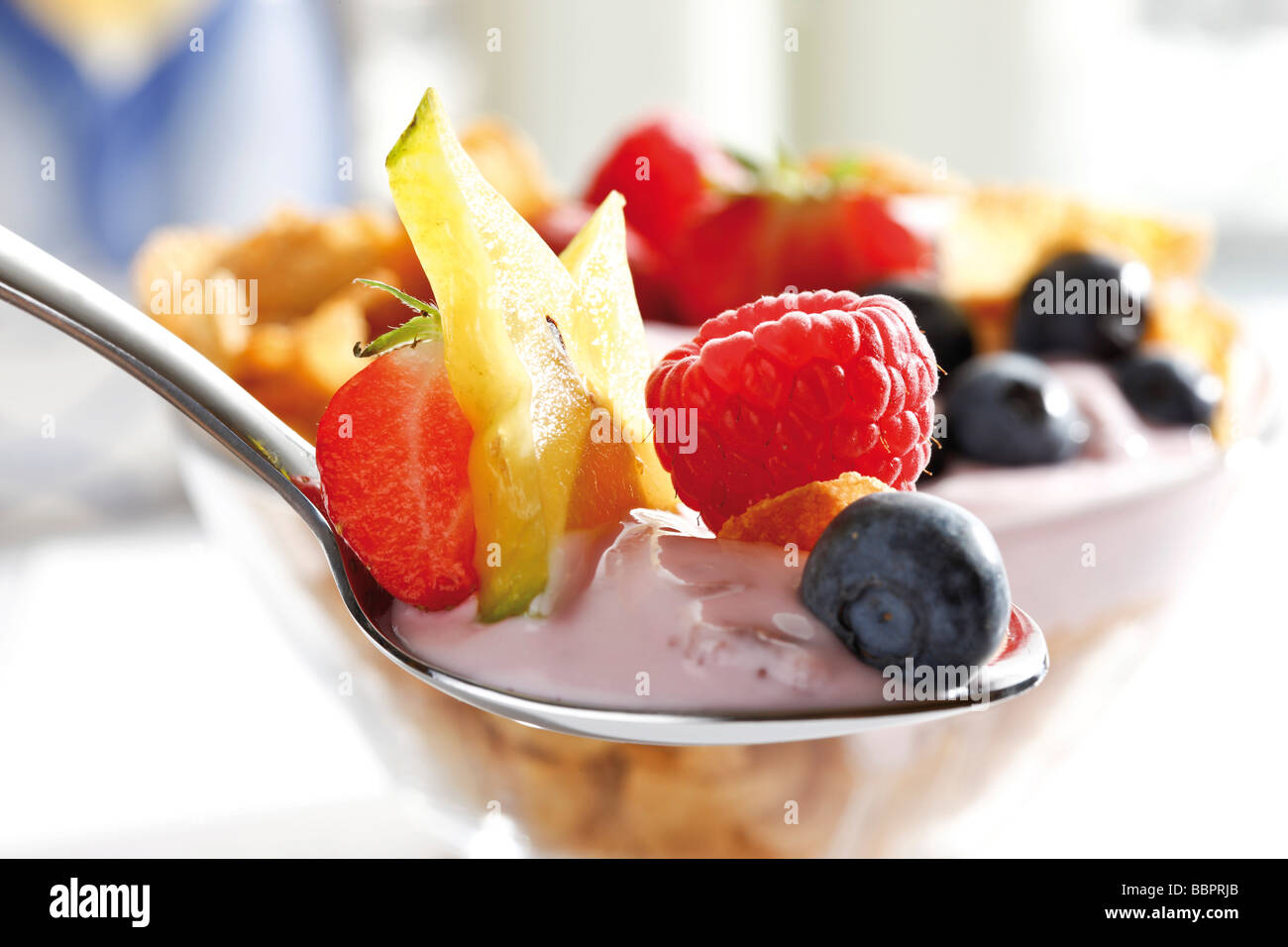 Spoon with yogurt and fruit Stock Photo Alamy