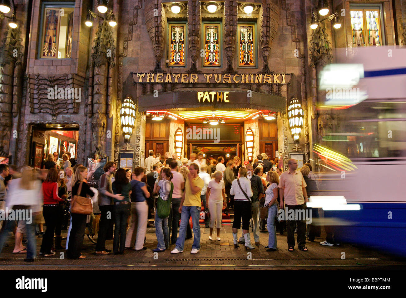TRAMWAY AND PUBLIC IN FRONT OF THE TUSCHINSKI THEATER, AMSTERDAM
