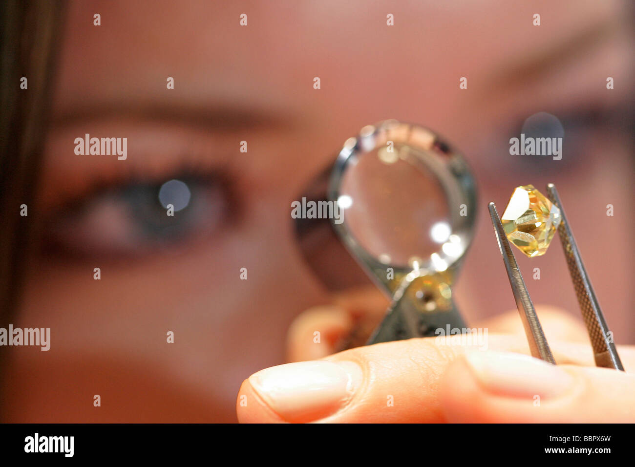 'GASSAN DIAMONDS' EXAMINED THROUGH A MAGNIFYING GLASS, VERY RARE YELLOW ...