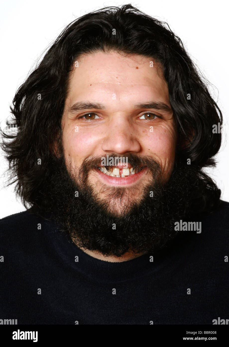 Long-haired man with beard and toothy grin Stock Photo