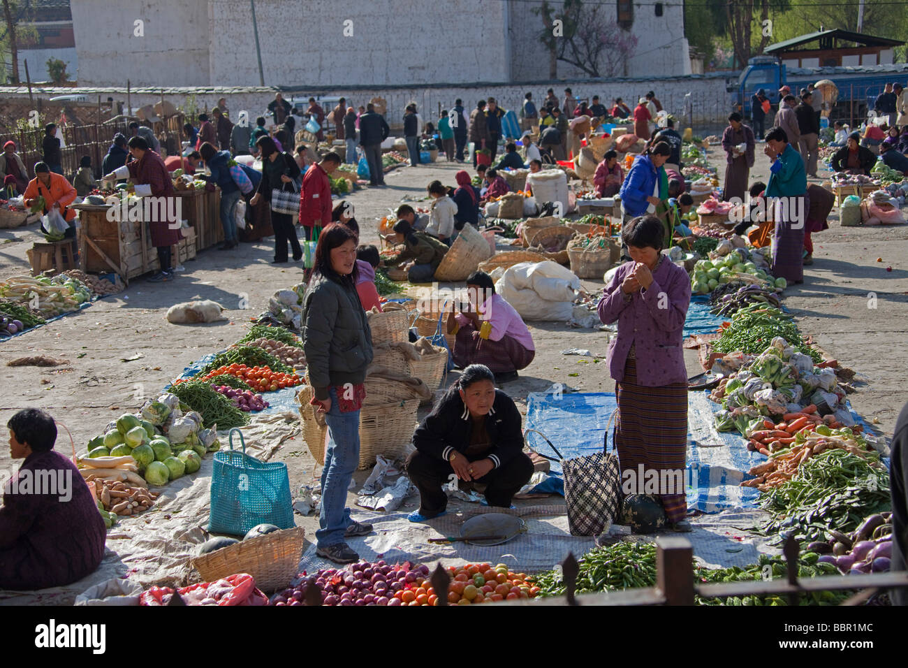 Market traders and shoppers at Paro vegetables and fruit market, Bhutan, Asia Stock Photo