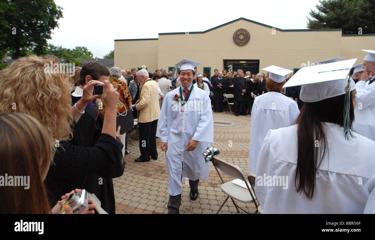 High school graduates get their picture taken during a commencement ceremony in Connecticut USA Stock Photo