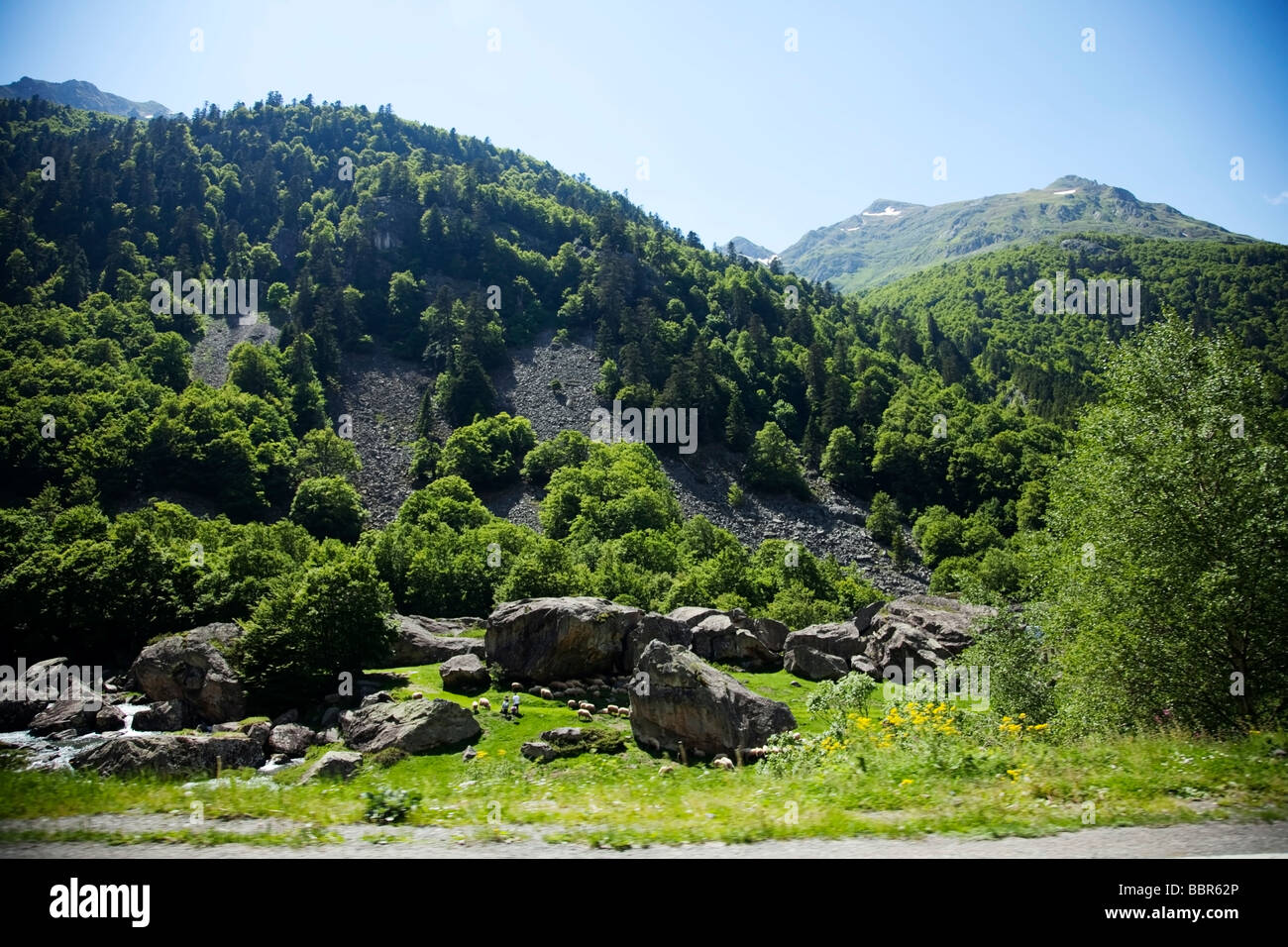 Green hills and stream by Pyrenees In France from a moving car. Stock Photo