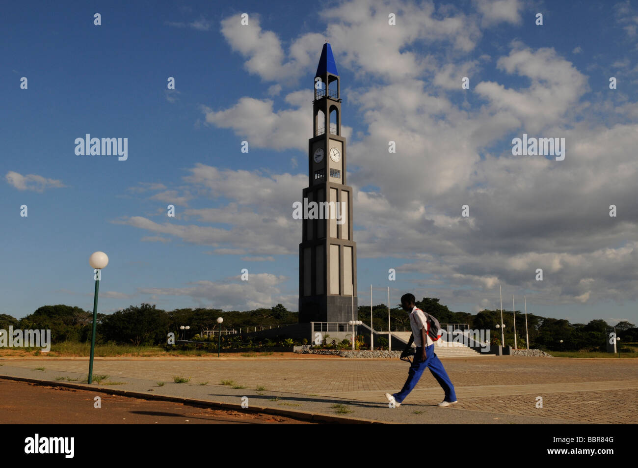 A pedestrian walks past King's African Rifles memorial tower to commemorate WWI and WWII in Lilongwe capital of Malawi Central Africa Stock Photo
