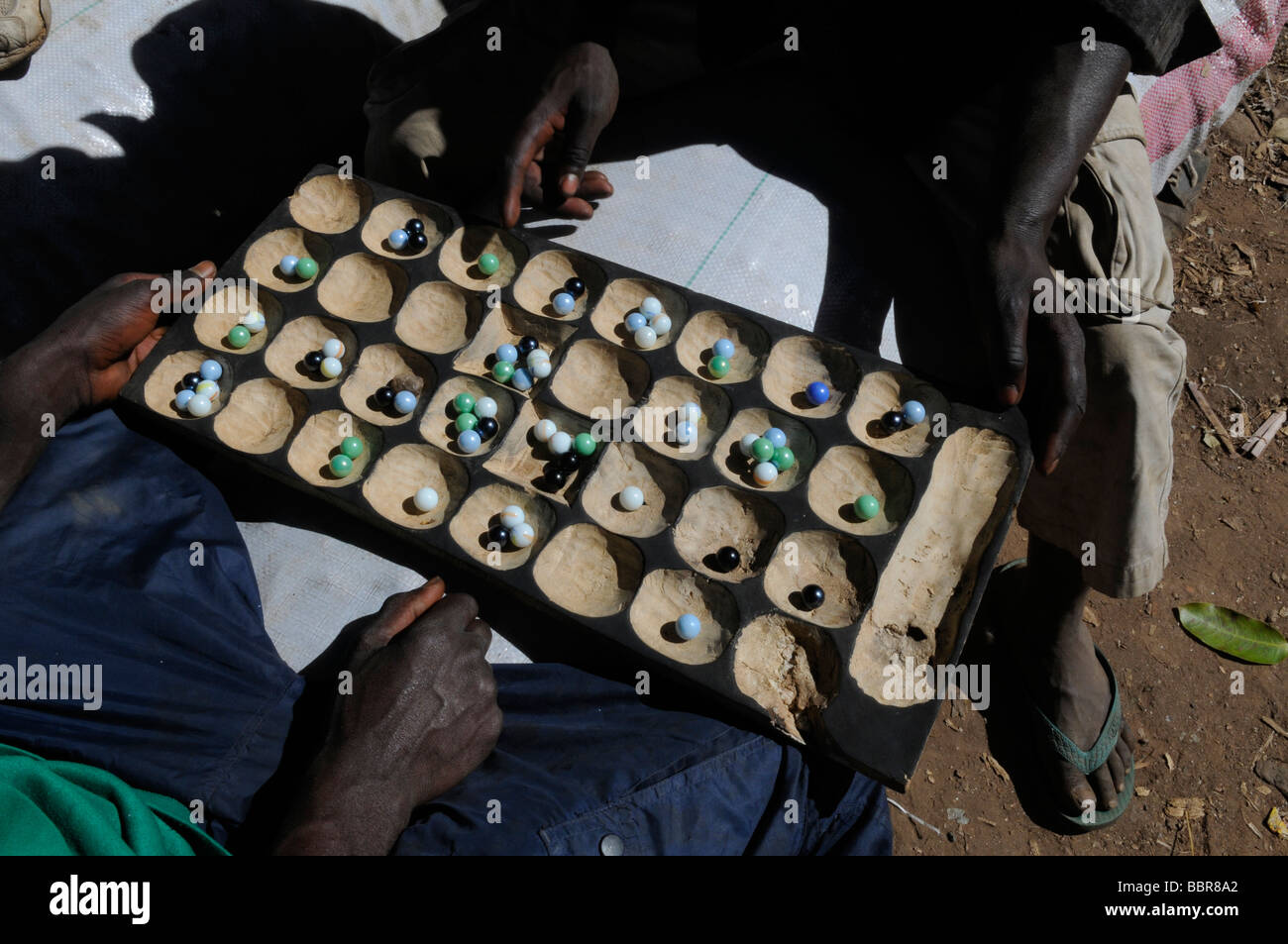 Men playing Bao traditional board game in Malawi Stock Photo