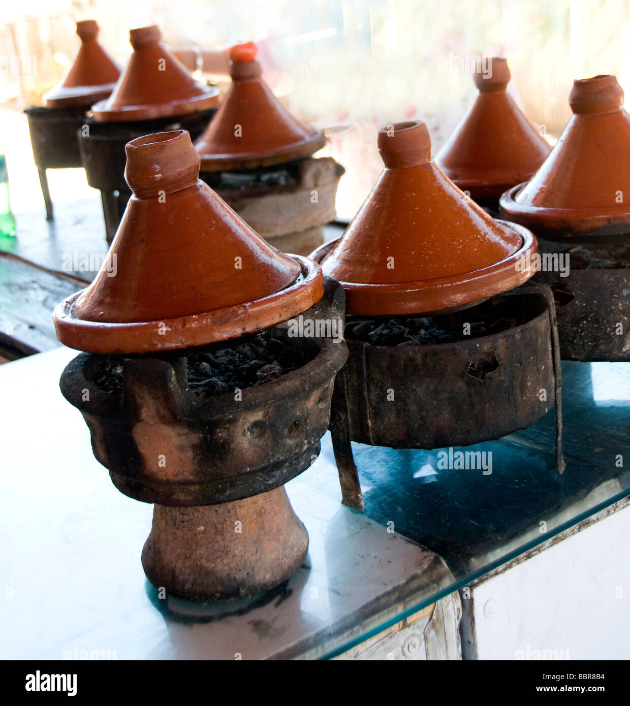 tagine ceramic cookware slow cooking over wood charcoal at outdoor restaurant morocco africa