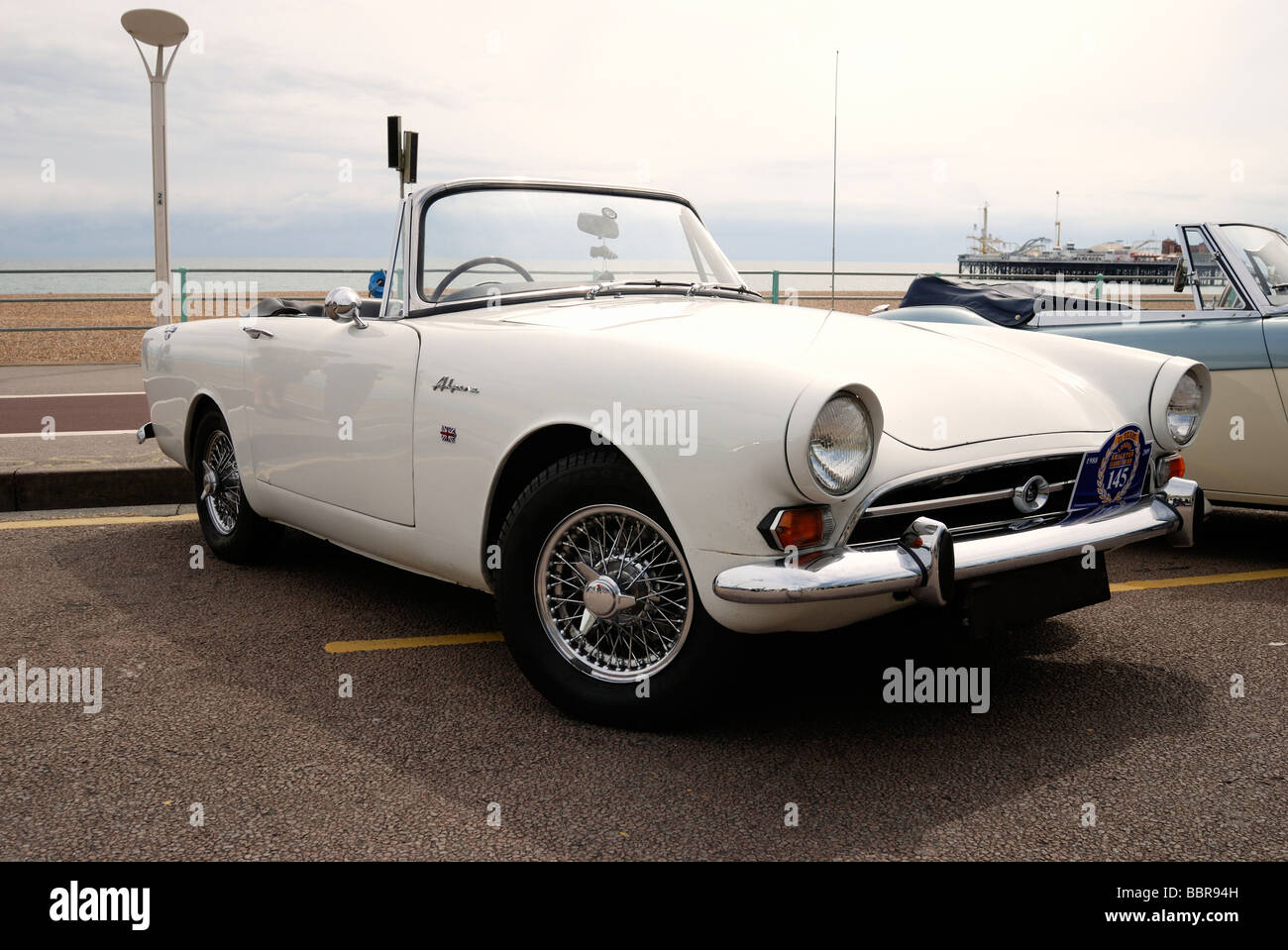 A white Sunbeam Alpine parked on the seafront Stock Photo