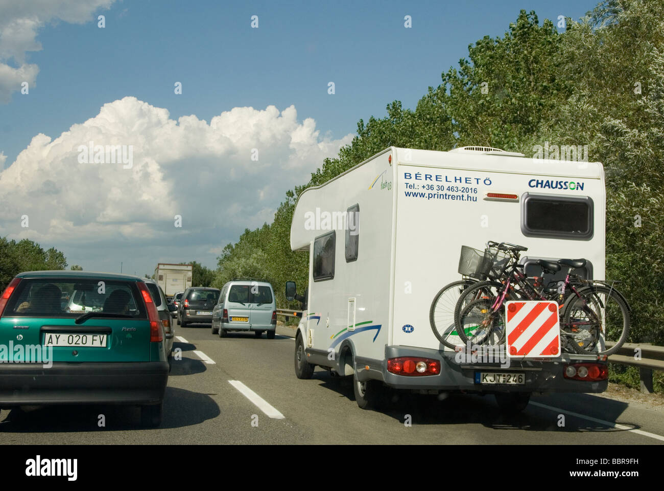 banked up holiday traffic in Italy with a campervan cars and trucks in front Stock Photo