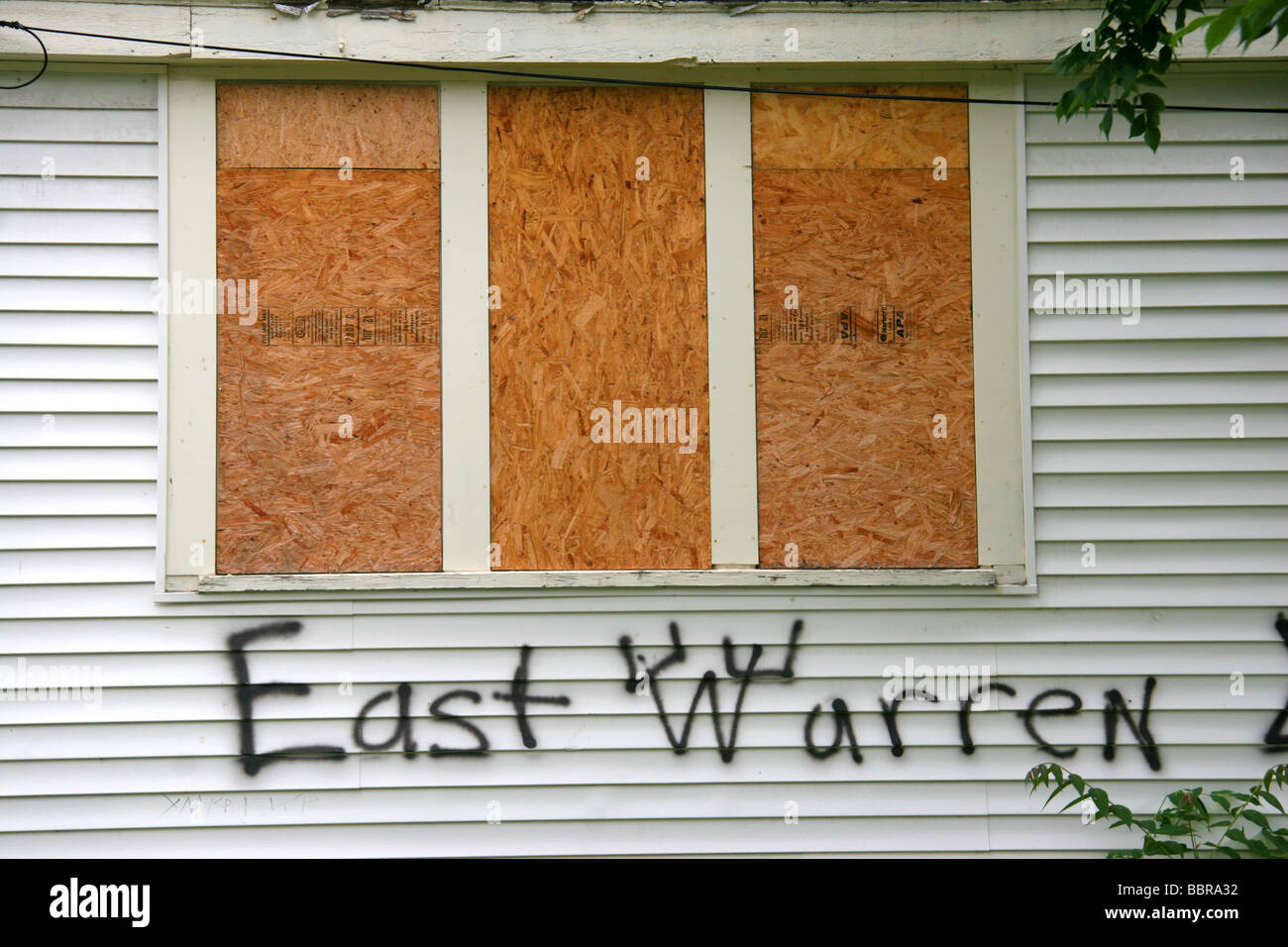 Boarded up house with gang markings and graffiti in Detroit Michigan USA Stock Photo
