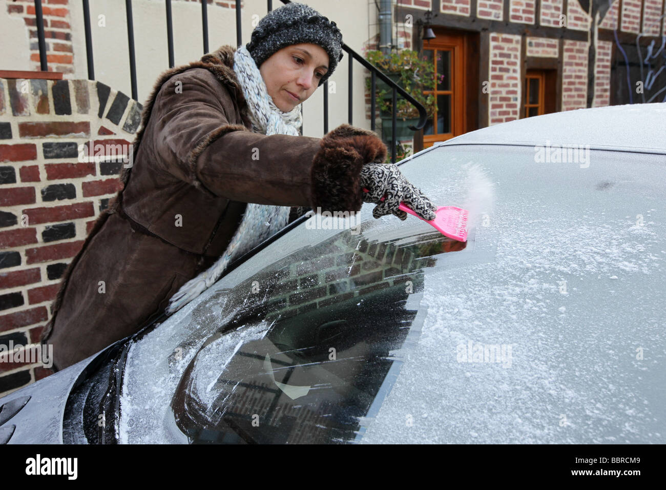 DEICING A WINDSHIELD WITH A CAR ICE SCRAPER, FRANCE Stock Photo Alamy