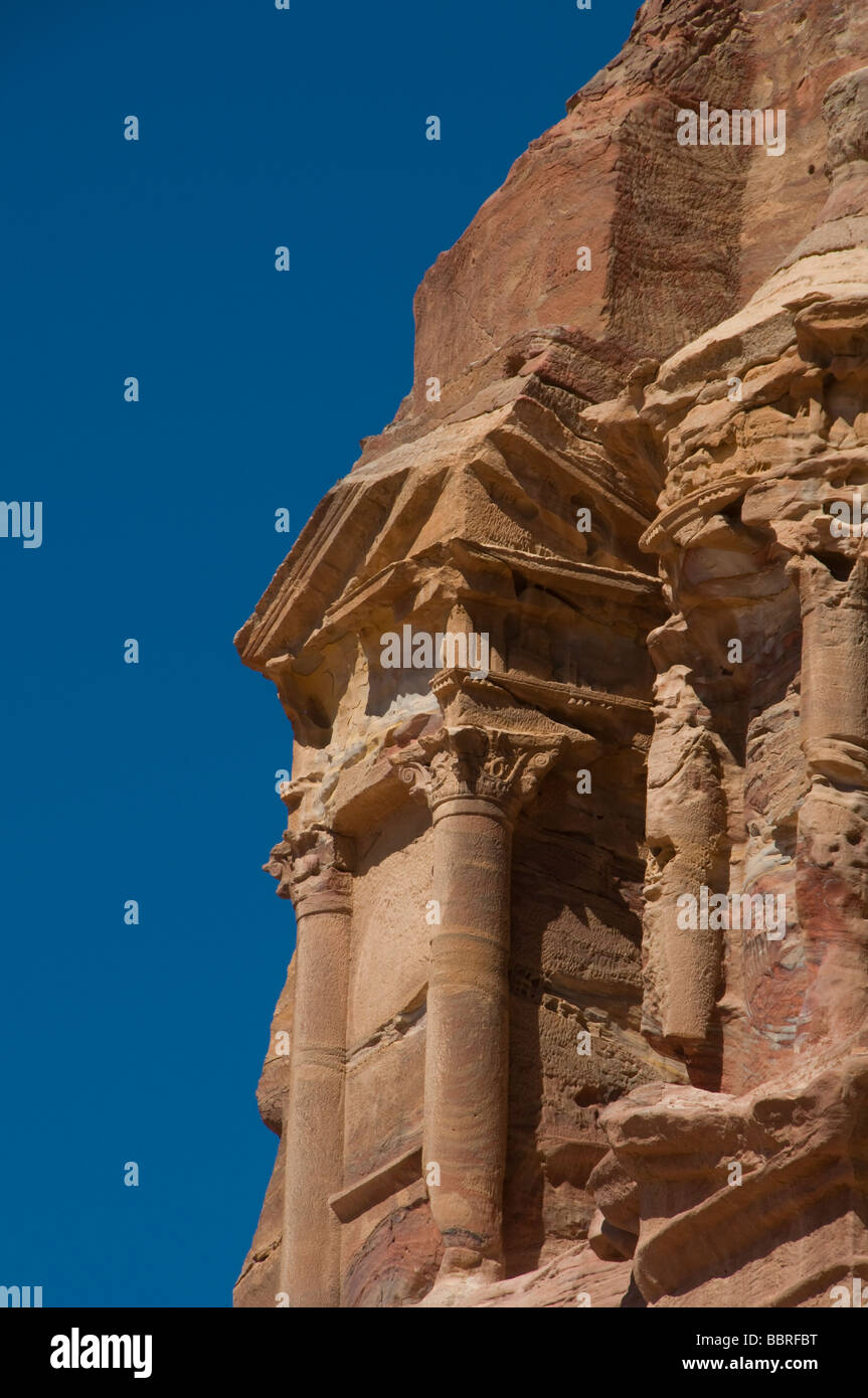 Cliff face of rock cut monument named the Corinthian Tomb in the ancient Nabatean city of Petra Jordan Stock Photo