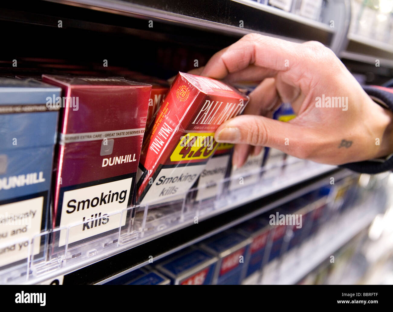 Packets of cigarettes made by British American Tobacco sit on the shelf of a retail store Stock Photo