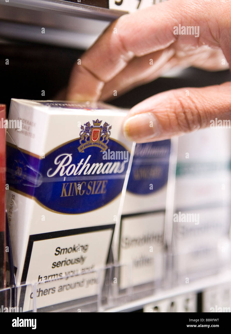 Packets of Rothmans cigarettes made by British American Tobacco sit on the shelf of a retail store Stock Photo