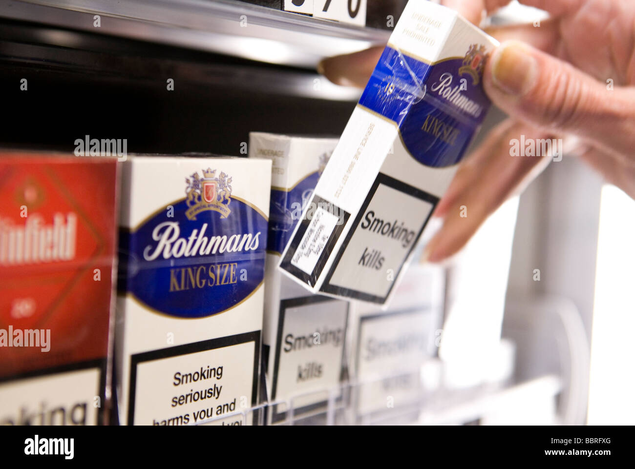 Packets of Rothmans cigarettes made by British American Tobacco sit on the shelf of a retail store Stock Photo