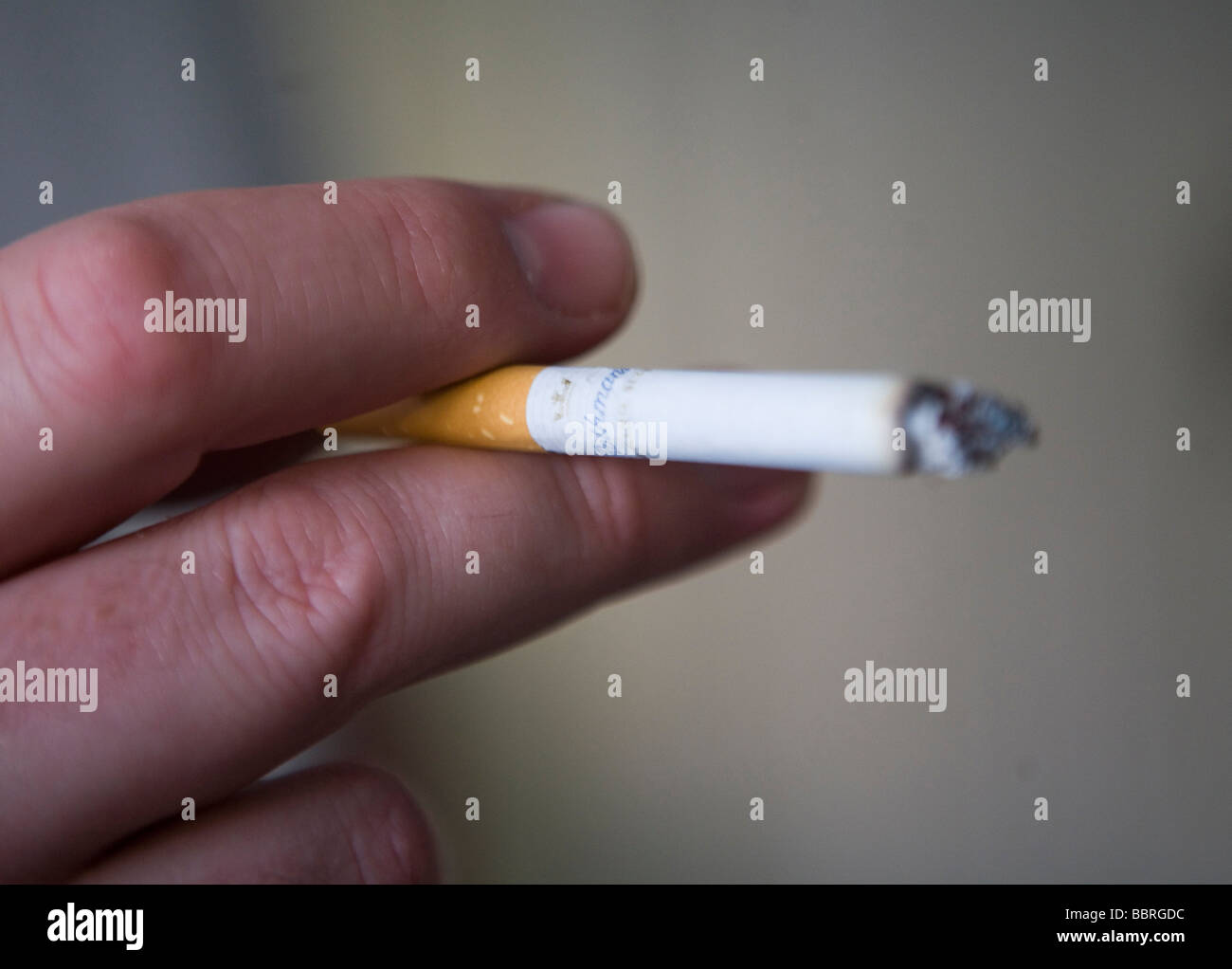 A smoker smokes a Rothmans cigarette made by British American Tobacco Stock Photo