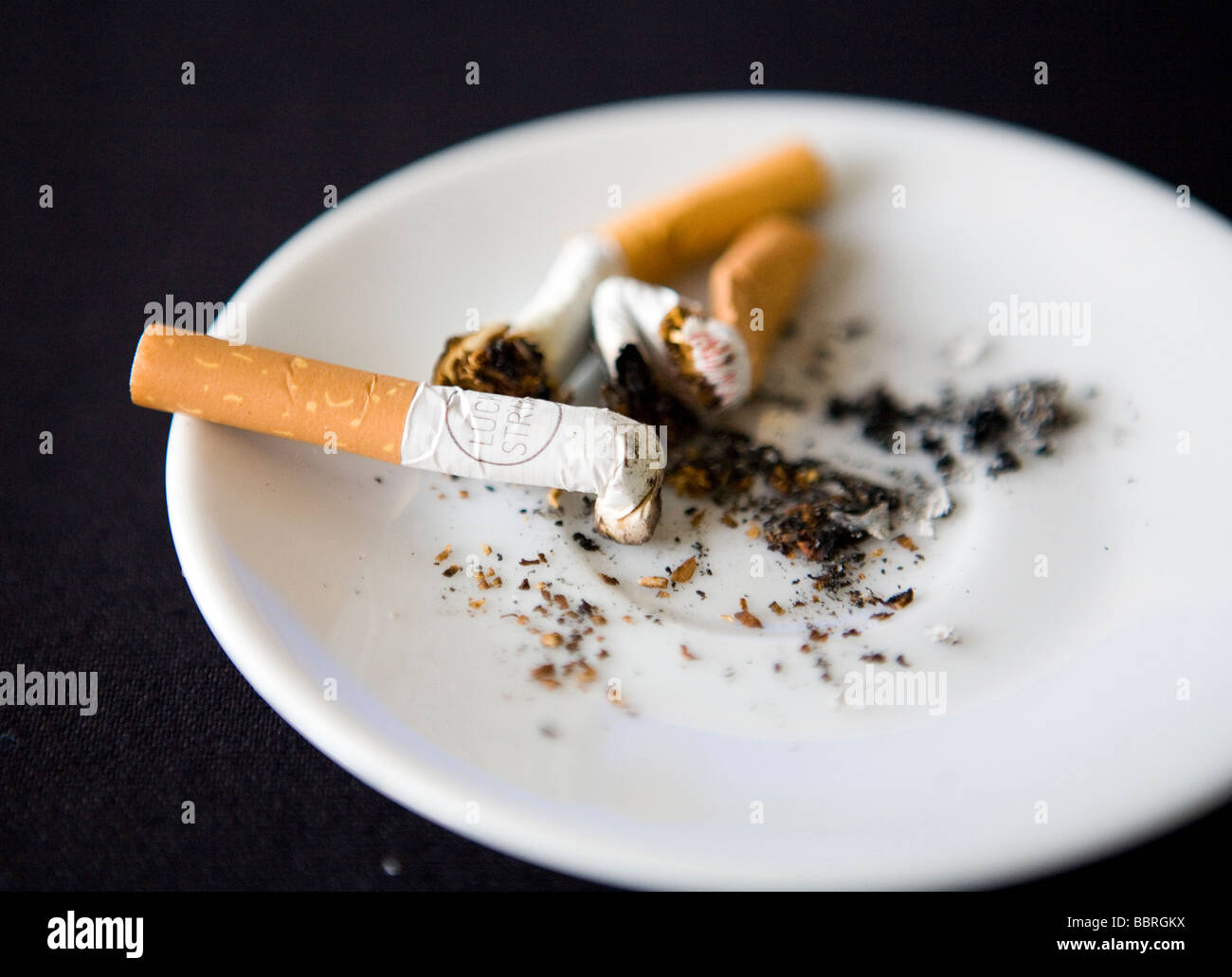Cigarettes made by British American Tobacco in an ashtray Stock Photo
