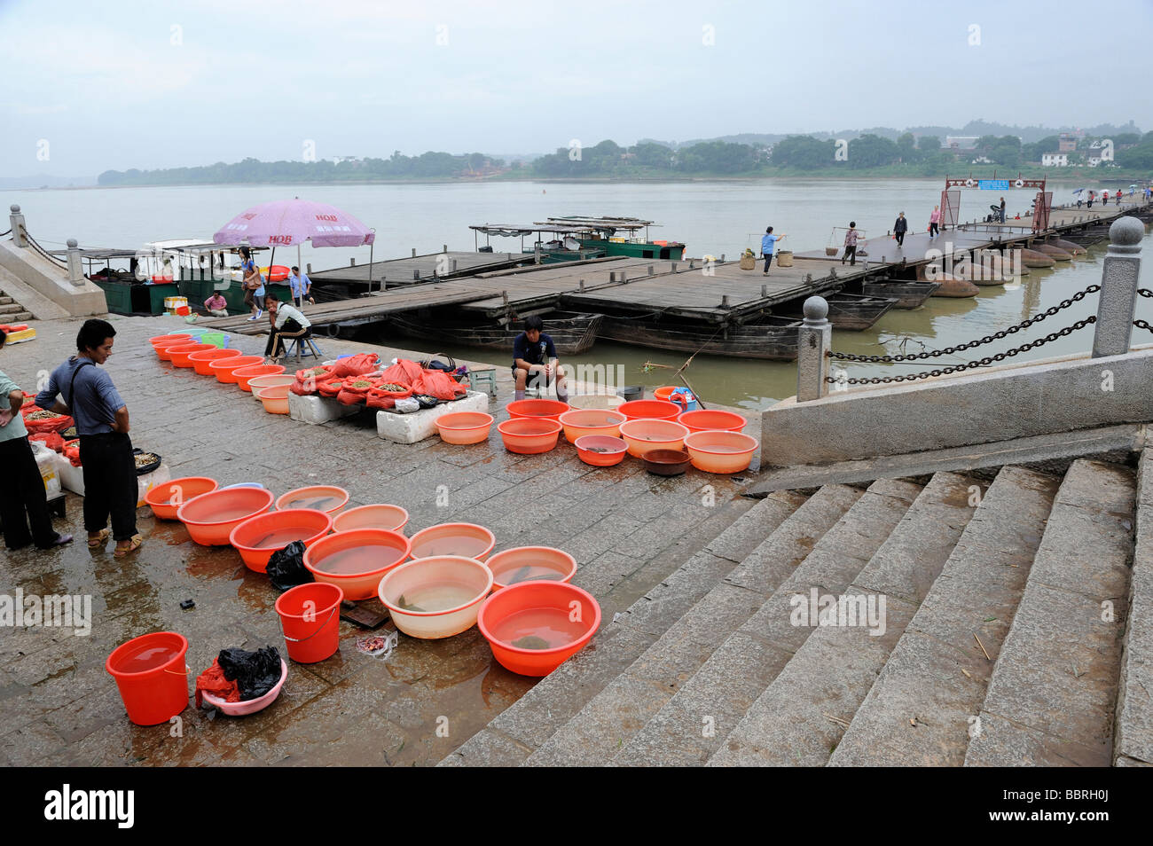 Fish venders near the ancient pontoon bridge over Ganjiang river in Ganzhou, Jiangxi, China. 2009 Stock Photo