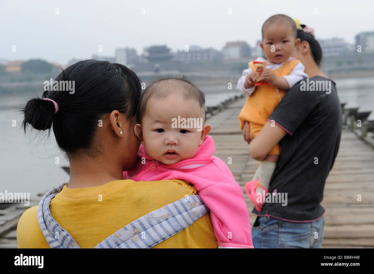 Chinese mothers hold babies in Ganzhou, Jiangxi, China. 11Jun2009