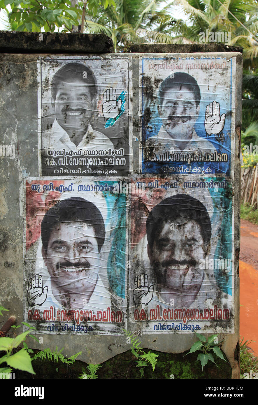 Old political campaign posters stuck to buildings in the Alleppey backwaters Stock Photo
