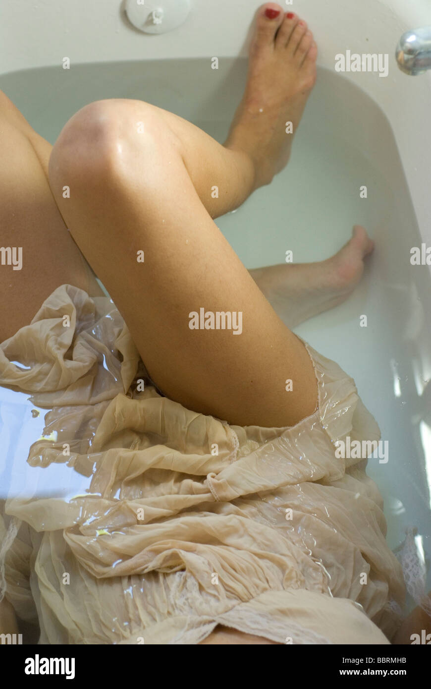 woman in the bath. Dress and details of body floating in the water Stock Photo