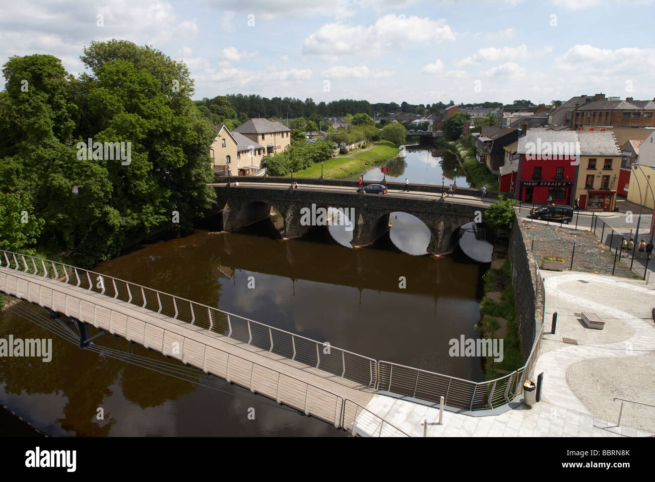 Scenic view of the River Strule flowing through Omagh town centre, with bridges and town buildings visible along the banks during daylight.