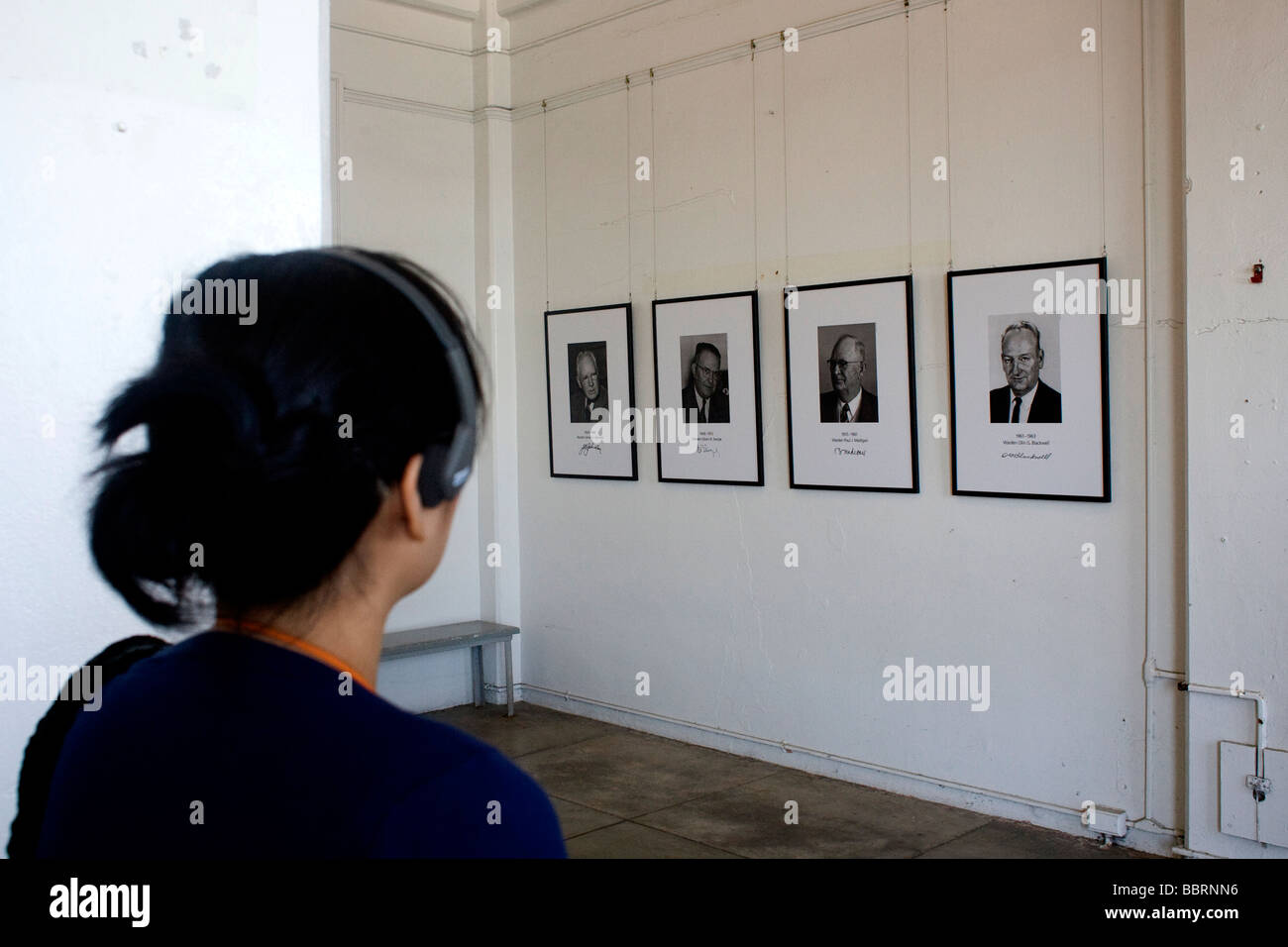 Visitor on the Alcatraz tour looks at photographs hanging in the office of previous wardens. Stock Photo