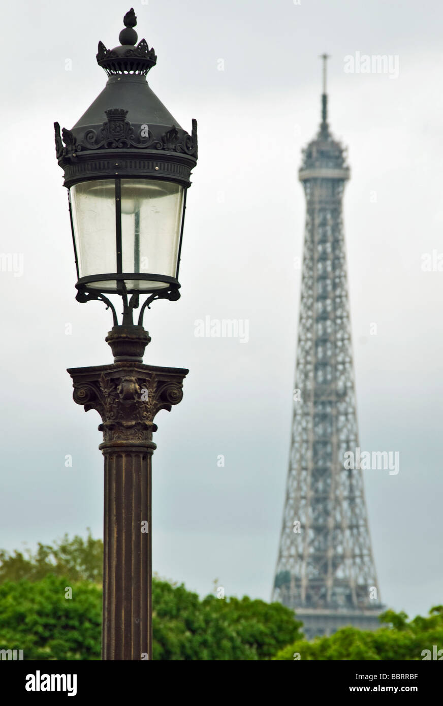 France Paris Champ-de-Mars Lamp Post In Front Of Eiffel Tower cloudy overcast sky grey Stock Photo