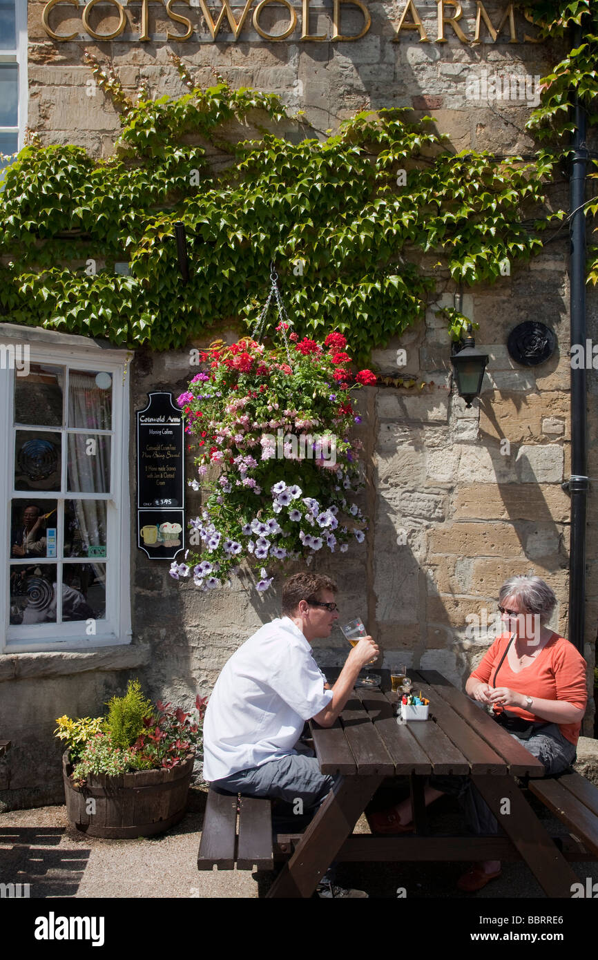 Tourists enjoy a drink in Burford UK Stock Photo