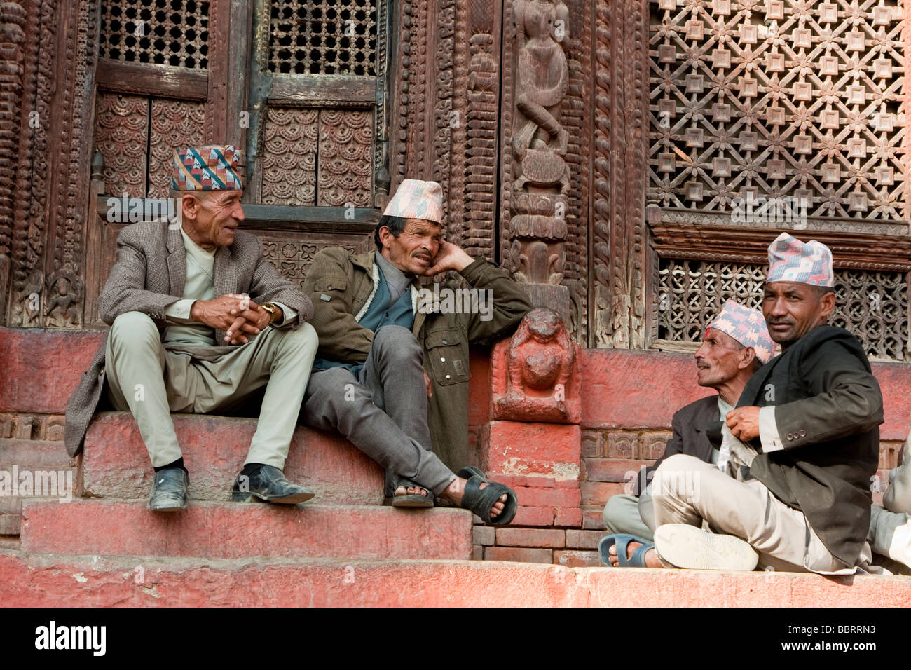 Kathmandu, Nepal. Nepali men talking on the steps of the Shiva Parvati Temple, Durbar Square. Stock Photo