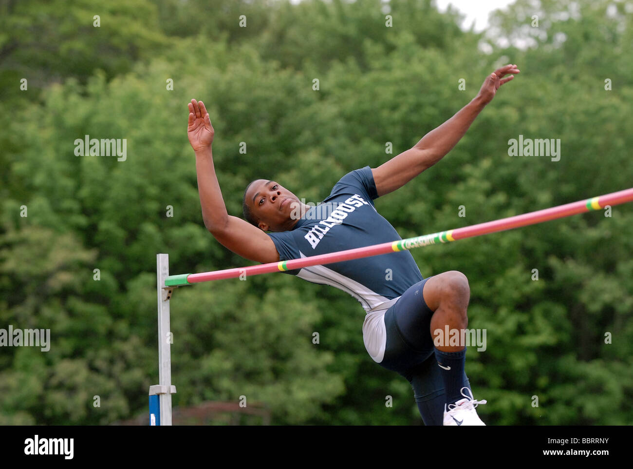 A High School track athlete jumps over the bar during the high jump during the Connecticut State Championship Track and Fields Stock Photo