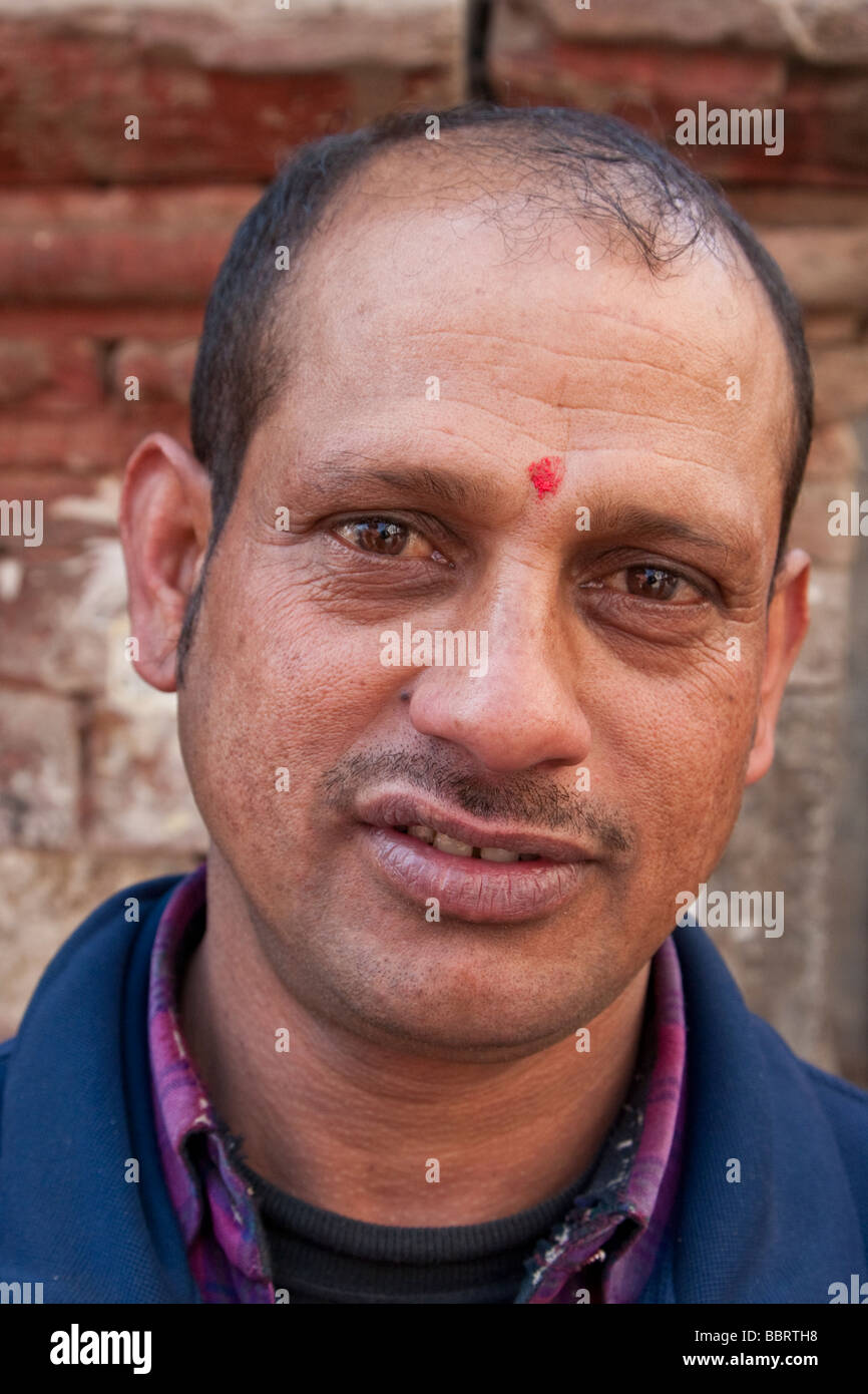Kathmandu, Nepal.   Nepali man wears a tikka on his forehead, a red mark serving as a blessing and a symbol of Hinduism. Stock Photo