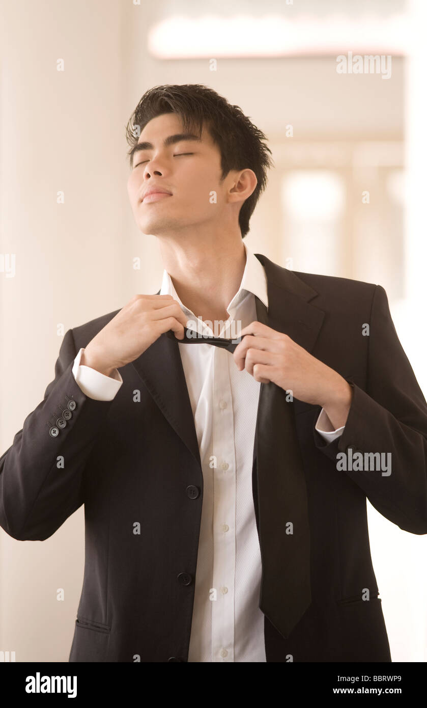 Businessman loosening his tie, looking frustrated Stock Photo