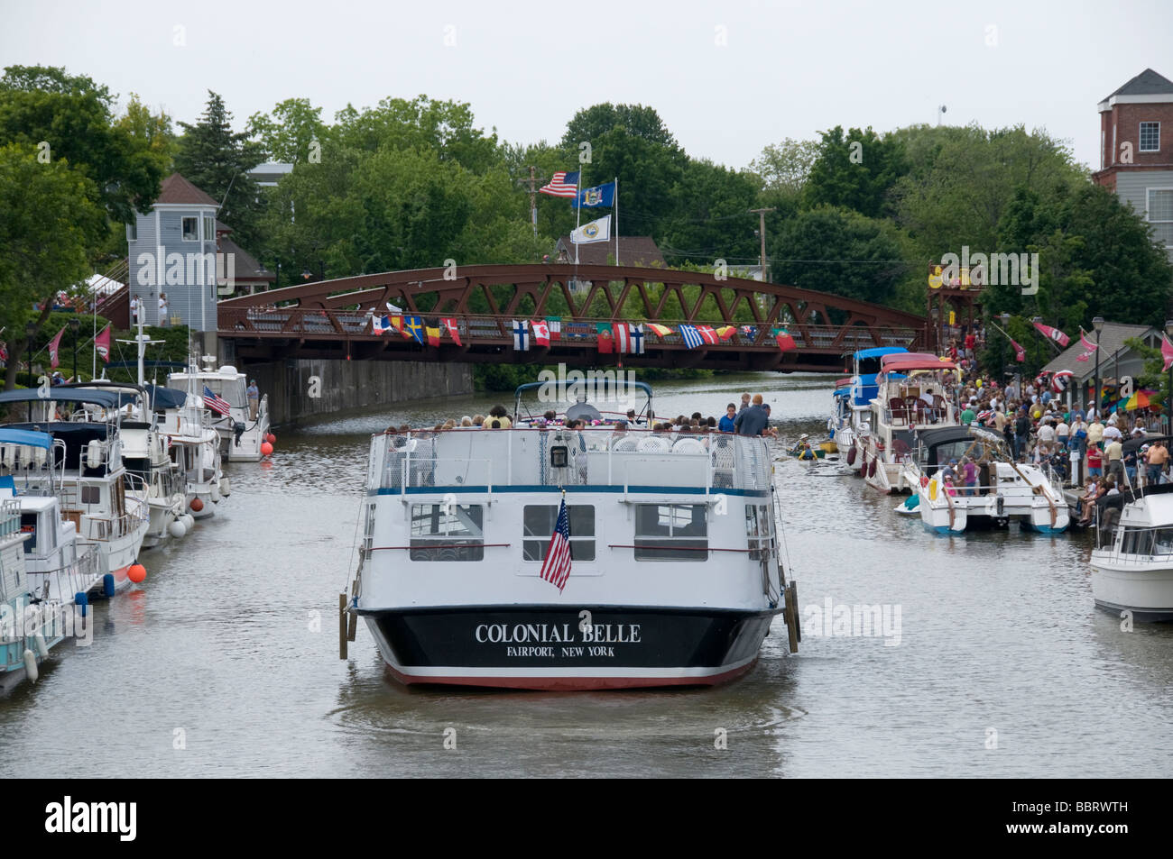 A dinner boat cruising down the Erie Canal in Fairport, NY USA Stock