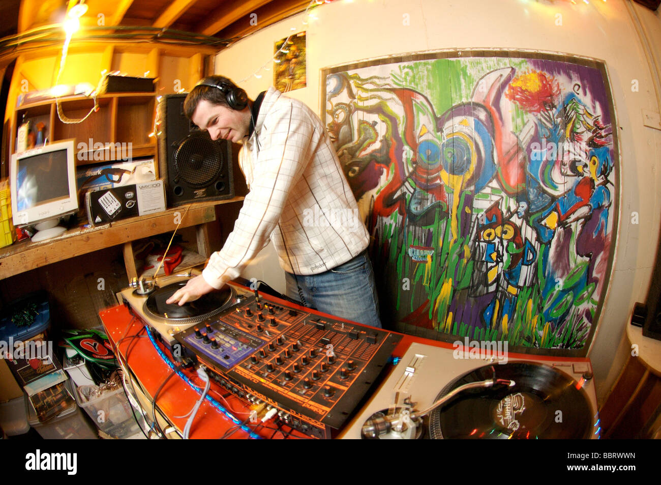 A Disk Jockey spins records at a night club Stock Photo